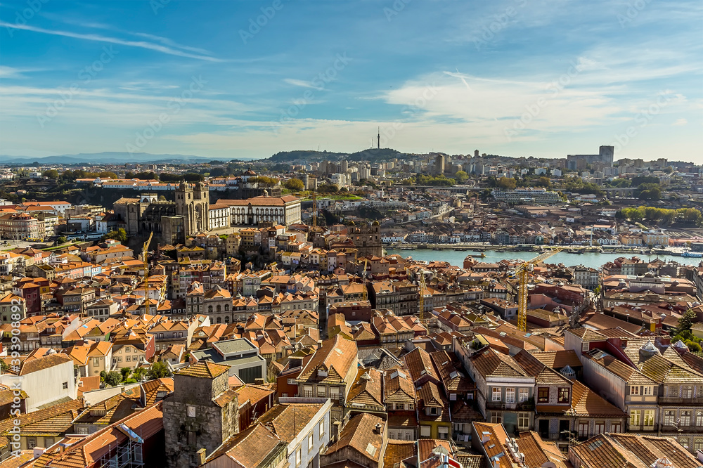 A view southward towards the cathedral across the roof tops of Porto, Portugal from the Clerigos Tower on a sunny afternoon
