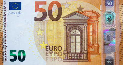 Fragment part of 50 euro banknote close up with brown details