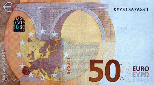 Fragment part of 50 euro banknote close up with brown details