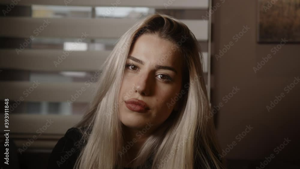 Attractive sexy blonde young woman poses looking at camera, lifestyle and fashion concept Attractive sexy blonde young woman poses looking at camera, lifestyle and fashion concept