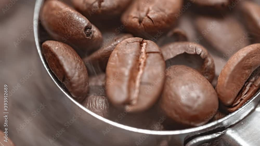 Close up of seeds of coffee. Fragrant coffee beans are roasted smoke comes from coffee beans. Close up of seeds of coffee. Fragrant coffee beans are roasted smoke comes from coffee beans.