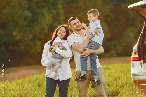 Family in a forest. People by the car. Sunset background. © prostooleh