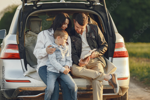 Family in a forest. People by the car. Sunset background. © prostooleh