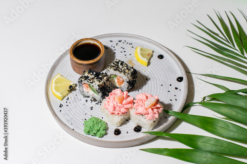 Sushi rolls on light ceramic plate