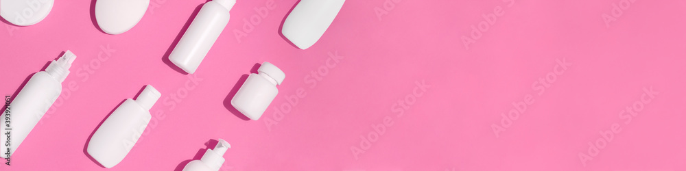 Banner with mock up pattern for branding on pink background. Tubes, bottles, dispensers and jars. Dietary supplements for beauty and health. Flat lay Banner with mock up pattern for branding on pink background. Tubes, bottles, dispensers and jars. Dietary supplements for beauty and health. Flat lay
