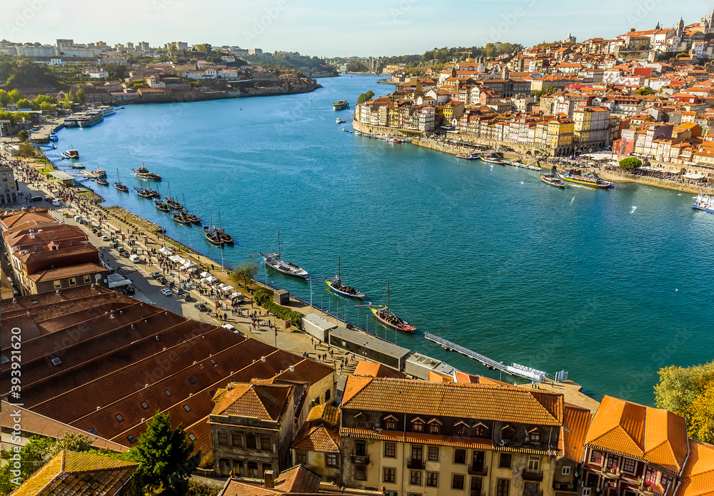 The Douro river, the Dom Luiz bridge and the old quarter of Porto, Portugal on a sunny afternoon