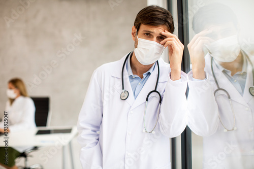 Male doctor looking away wi...