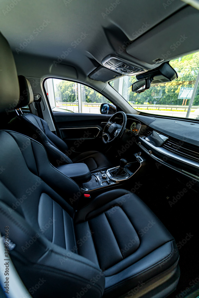 Interior of a new luxury car. Black salon of auto. Modern new transport. Closeup.