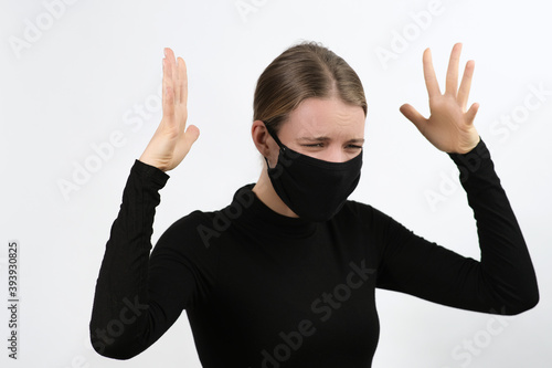 Young woman wearing virus face protection mask and expressing feelings, sadness, screaming. Coronavirus, covid-19