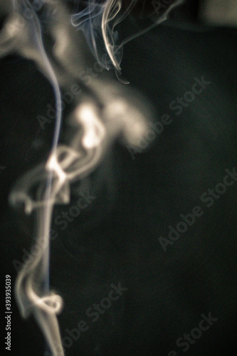 Abstract white smoke forms and spirals on black background 4