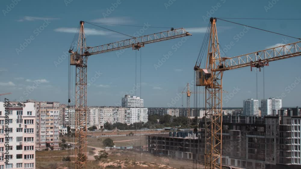 Time lapse of giant yellow constructor crane work on a building site with blue sky on background, Building industry work Time lapse of giant yellow constructor crane work on a building site with blue sky on background, Building industry work