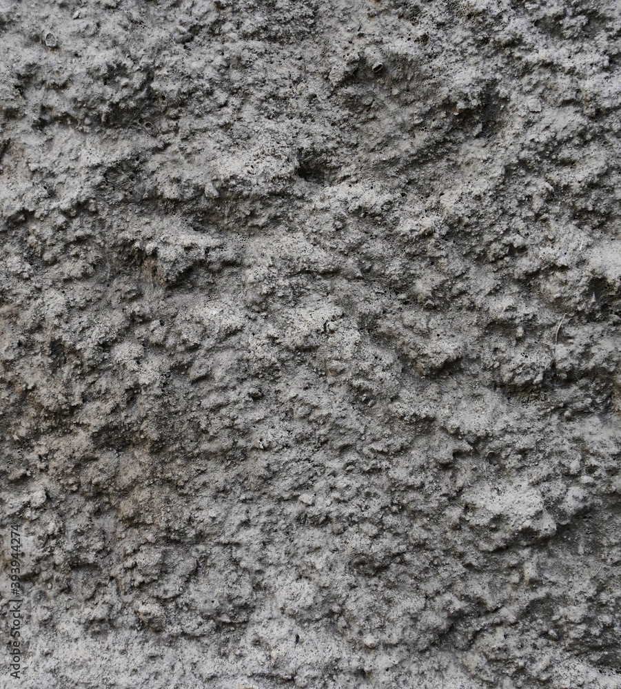 Texture and background for the material. Unique pattern of gray cement texture in the pimples of the wall. Texture and background for the material. Unique pattern of gray cement texture in the pimples of the wall.