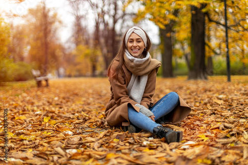 Portrait of smiling young woman in a park in autumn 