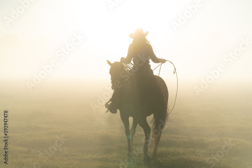 silhouette of cowgirl on a horse