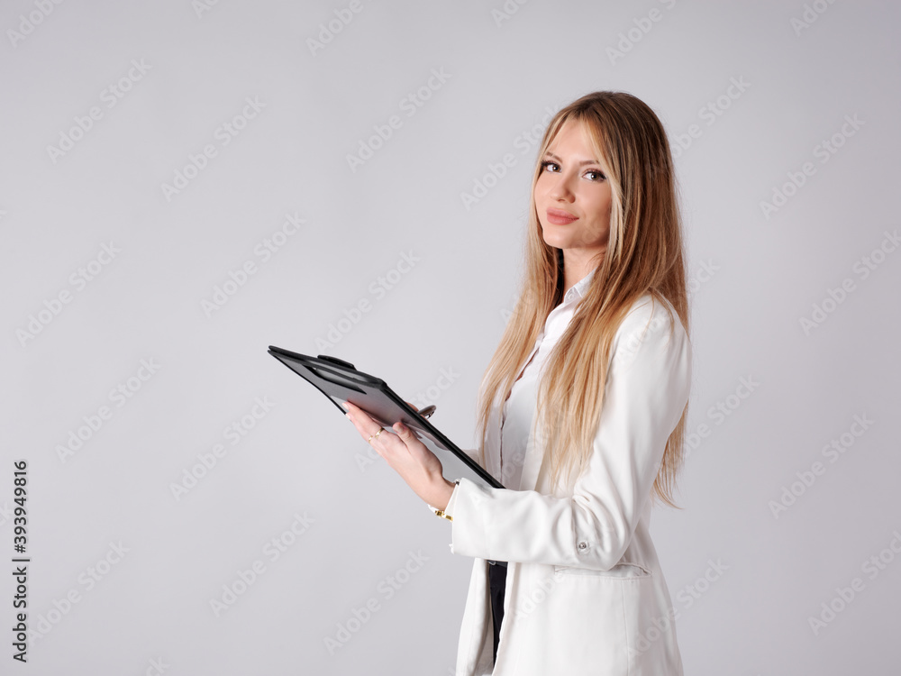 Young business woman taking notes in a folder Young business woman taking notes in a folder