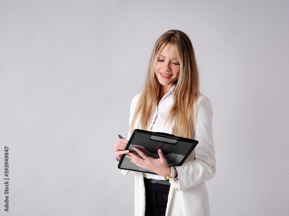 Young business woman taking notes in a folder Young business woman taking notes in a folder