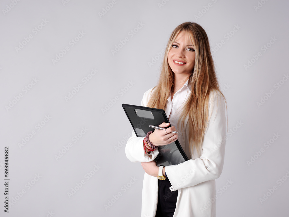 Young business woman taking notes in a folder Young business woman taking notes in a folder