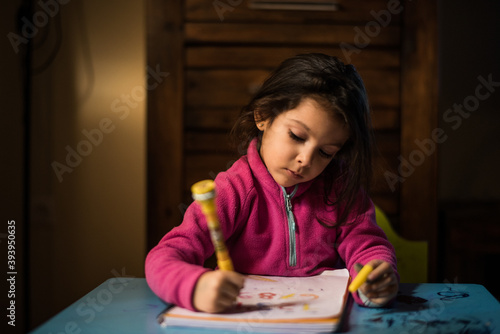 Drawing little girl at home photo