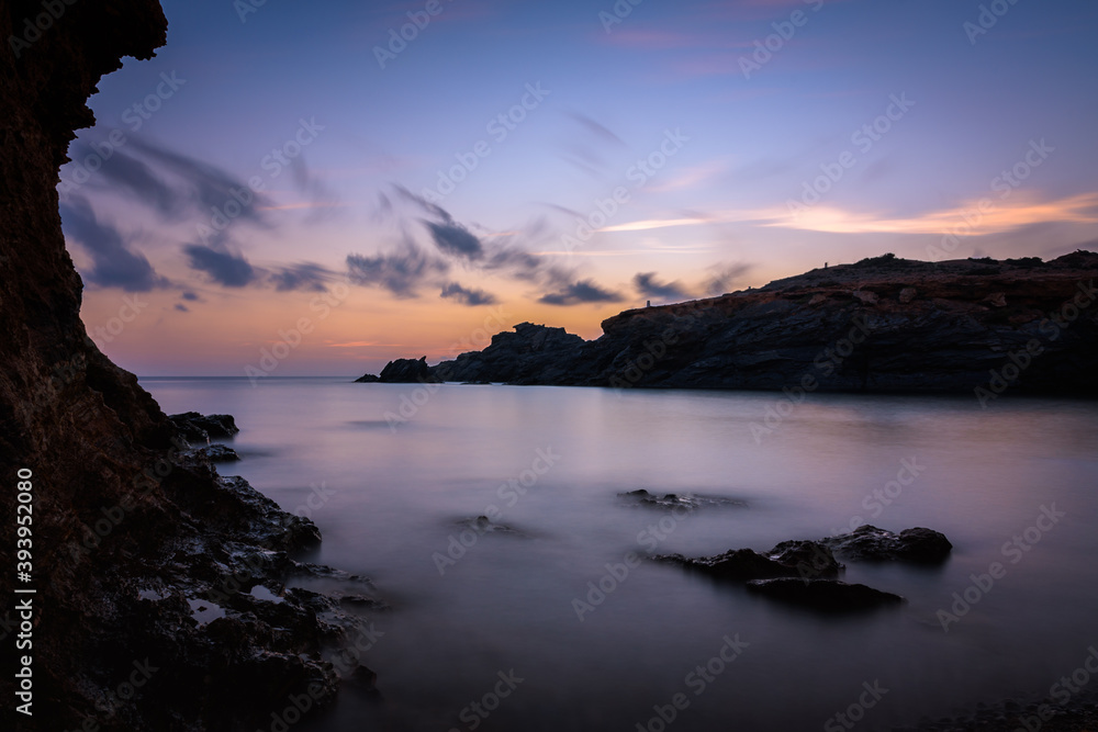 Beautiful and colorful sunrise from a rocky beach in Cabo de Palos, Murcia, Spain