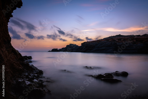 Beautiful and colorful sunrise from a rocky beach in Cabo de Palos, Murcia, Spain
