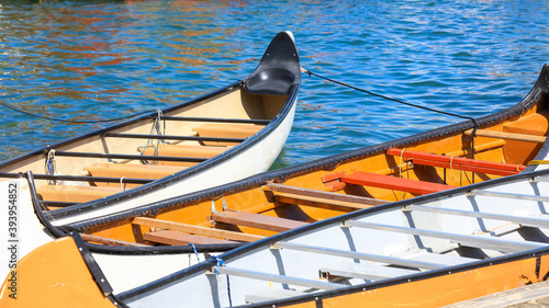 Photography Three colorful vintage style canoes in Lake Ontario