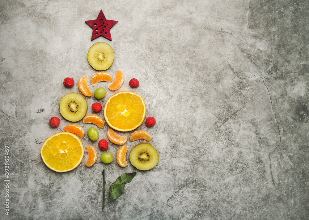 Christmas concept background. Pieces of fruit in the form of a christmas tree