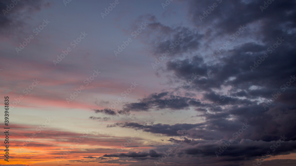 Dramatic big clouds in the vast sunset sky