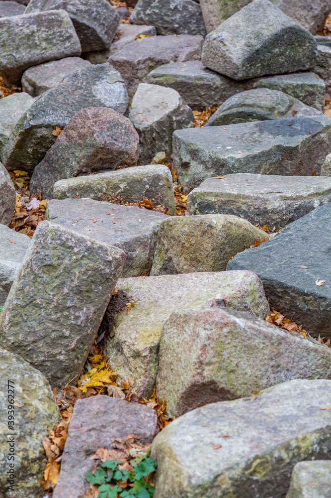 Untreated rough natural stone in everyday environment, gardening and landscaping Untreated rough natural stone in everyday environment, gardening and landscaping