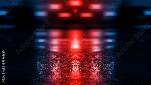 Neon futuristic landscape of a night street with neon light reflected in the water. Wet street, red and blue neon lights. Urban neon abstraction. Dark street wet asphalt reflections of rays.
