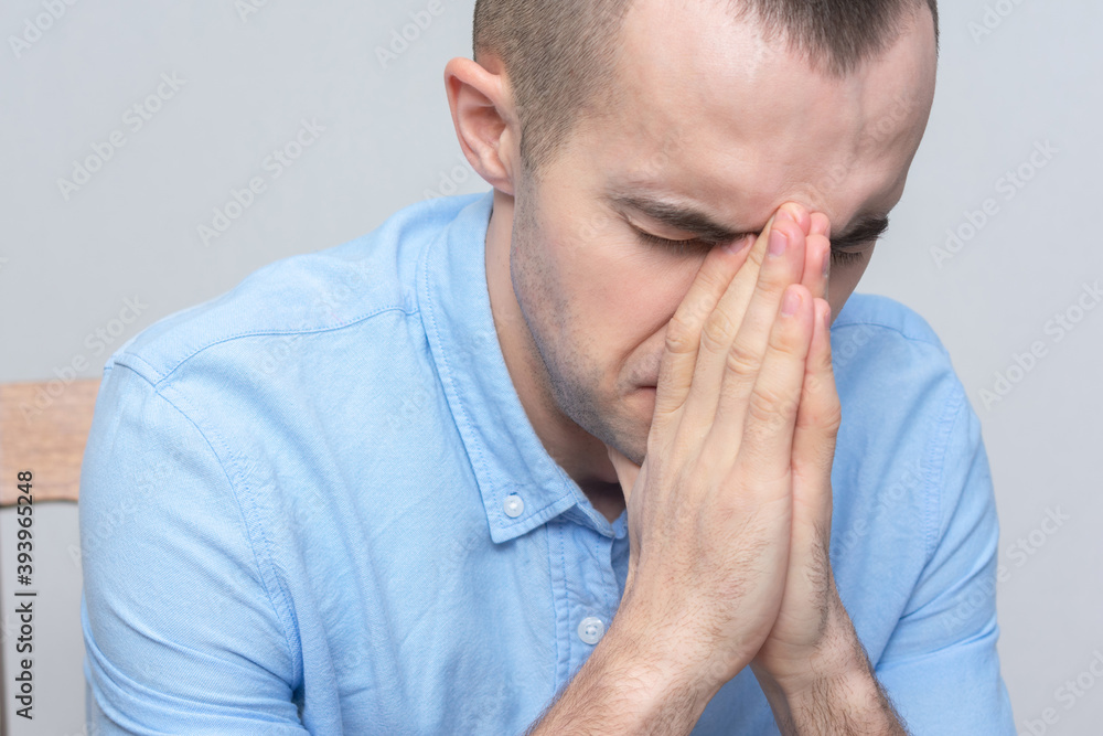 Sad guy prays sitting down, portrait, closeup Sad guy prays sitting down, portrait, closeup