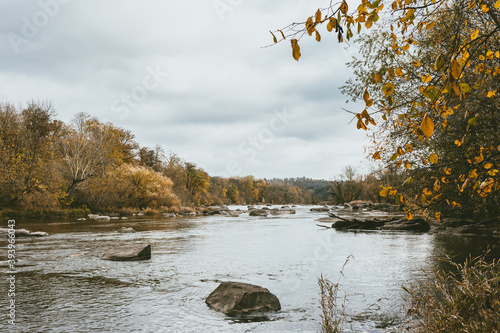 Beautiful autumn landscape with a river and a forest. Late fall.