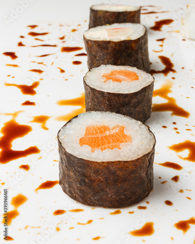 Vertical shot of fresh sushi rolls on white background