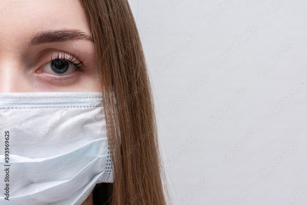 Φωτογραφία Girl in medical face mask due to air, half face, portrait, closeup, white backgr