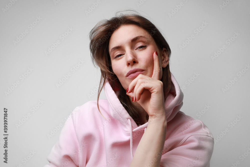 Young woman with wondering face expression, posing on white background wall. Young woman with wondering face expression, posing on white background wall.