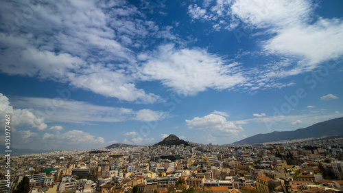 Limestone Hill with city buildings in Athens, blue sky