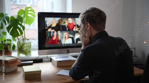 Man Fatigue during home video conference meeting call. Post-work exhaustion from constant face-to-face digital interactions. Working remotely Stay connected during pandemic to combat loneliness