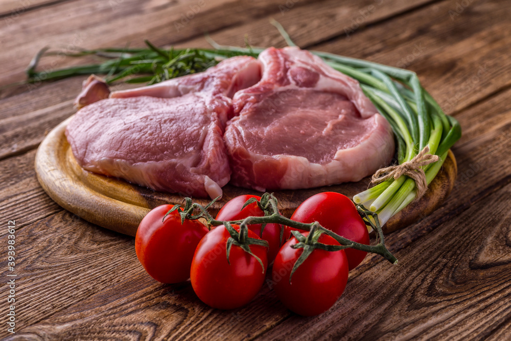 fresh raw new-york steak on wooden Board on wooden background with salt and pepper in a rustic style. fresh raw new-york steak on wooden Board on wooden background with salt and pepper in a rustic style.