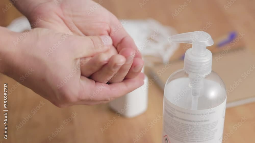 Man using hand sanitizer alcohol gel for disinfection, takes bottle with therapeutic white pills, antibiotic treatment, or painkiller. Coronavirus or covid-19 pandemic spread prevention Man using hand sanitizer alcohol gel for disinfection, takes bottle with therapeutic white pills, antibiotic treatment, or painkiller. Coronavirus or covid-19 pandemic spread prevention