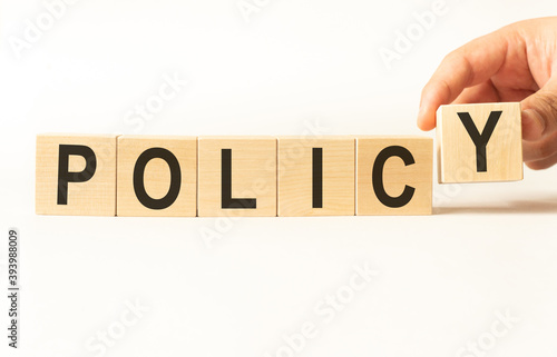 Word policy. Wooden small cubes with letters isolated on white background with copy space available.Business Concept image.