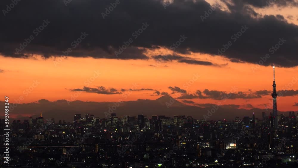 TOKYO, JAPAN : Aerial sunrise CITYSCAPE of TOKYO and MOUNT FUJI. View of rising sun and buildings at downtown. Japanese city life and nature concept. Time lapse tracking shot night to morning. TOKYO, JAPAN : Aerial sunrise CITYSCAPE of TOKYO and MOUNT FUJI. View of rising sun and buildings at downtown. Japanese city life and nature concept. Time lapse tracking shot night to morning.