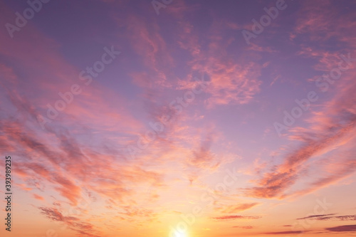 Soft sunrise, sunset pink violet orange sky with sun, clouds background texture