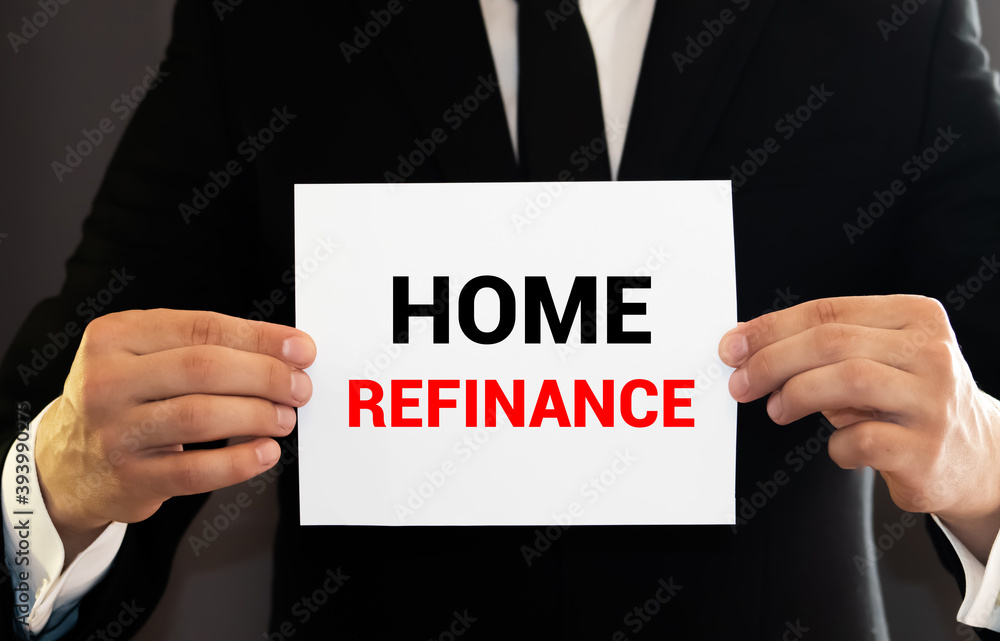 Businessman holding a card with text Home refinance Businessman holding a card with text Home refinance