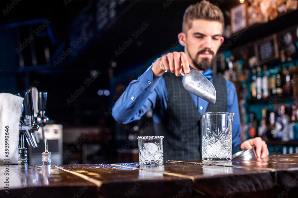 Experienced bartender demonstrates his skills over the counter in the night club