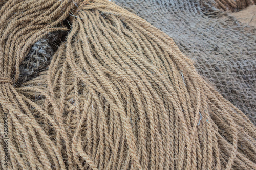 Manila hemp products background: nautical ropes, fishing nets, twine, sacks photo