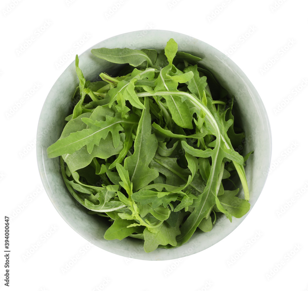 Delicious fresh arugula in bowl isolated on white, top view Delicious fresh arugula in bowl isolated on white, top view