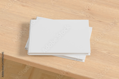 Horizontal or landscape white hardcover book stack mockup on the wooden table.