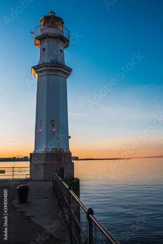 Lighthouse by the sea at sunset in Leith.