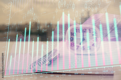 Multi exposure of financial graph drawings and desk with open notebook background. Concept of forex © peshkova