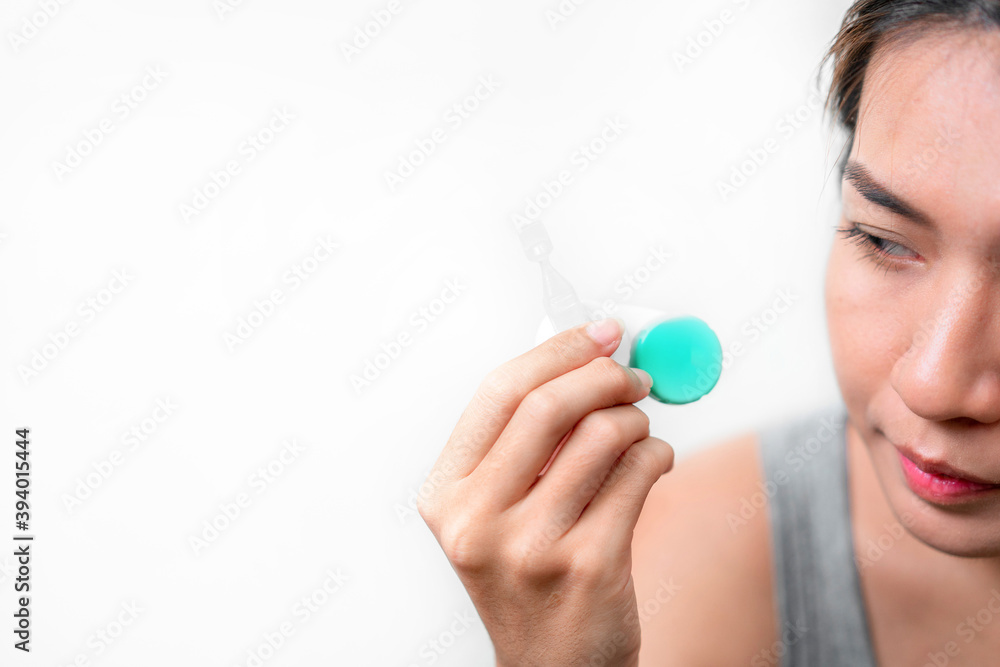 Asian woman holding contact lens and artificial tears on white background, Selective focus on contact lens , myopia and eyesight problem concept. Asian woman holding contact lens and artificial tears on white background, Selective focus on contact lens , myopia and eyesight problem concept.