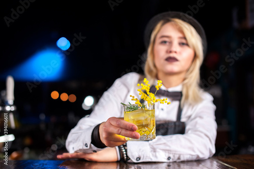 Girl barman formulates a cocktail on the pothouse photo